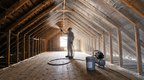 Radiant barrier paint sprayer equipment in an attic with coated framing surfaces